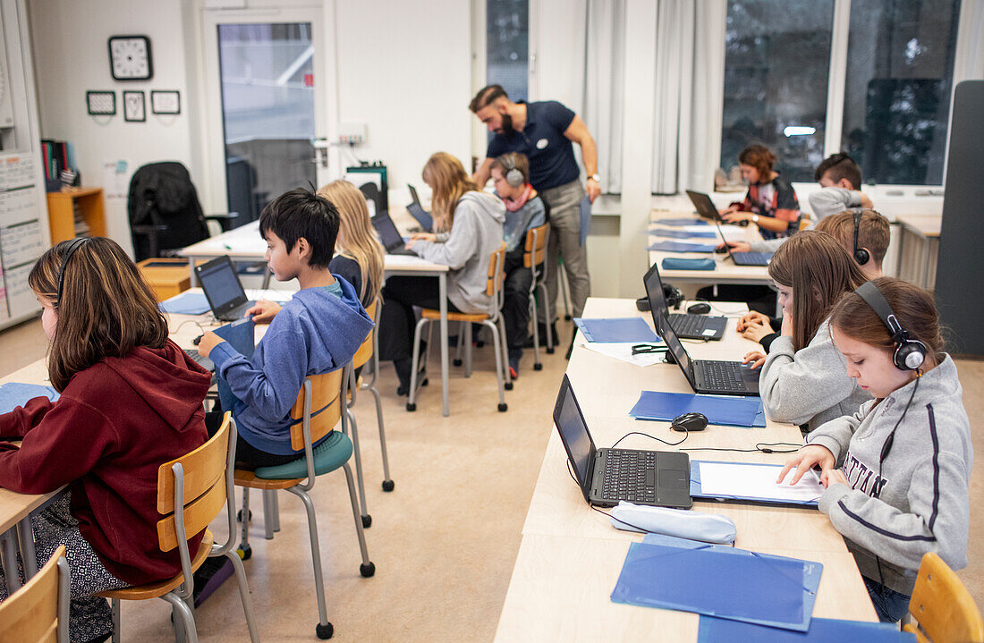 Children in classroom using laptops