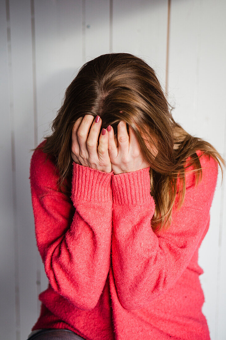 Woman covering her face