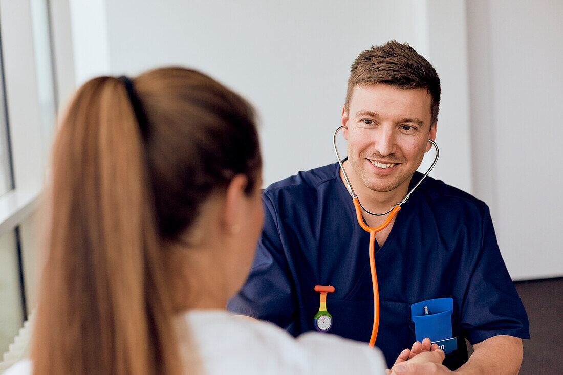 Young doctor examining patient