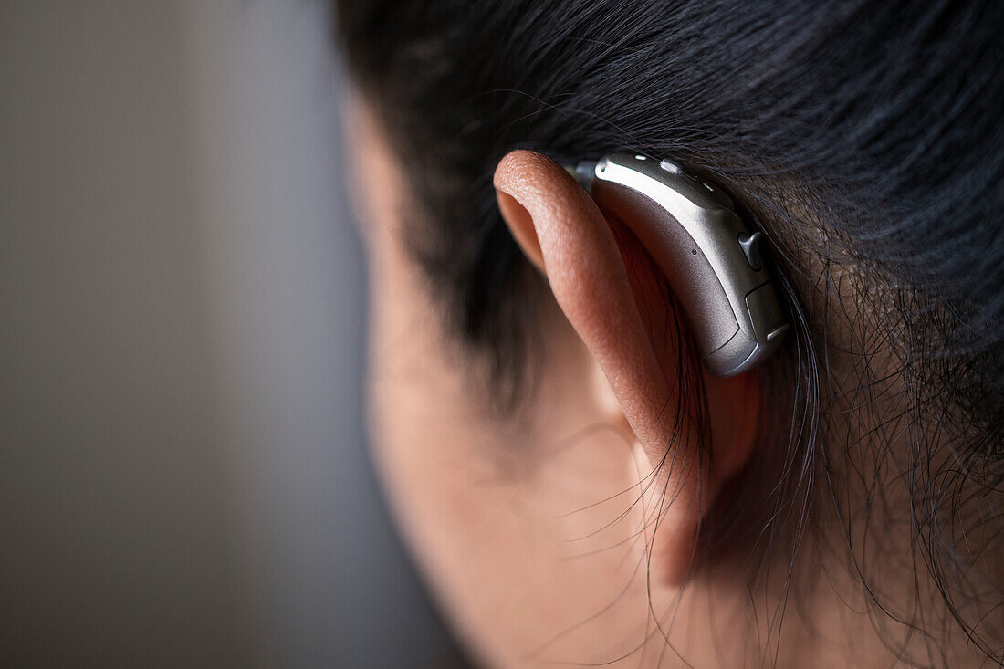 Close-up of woman with hearing aid