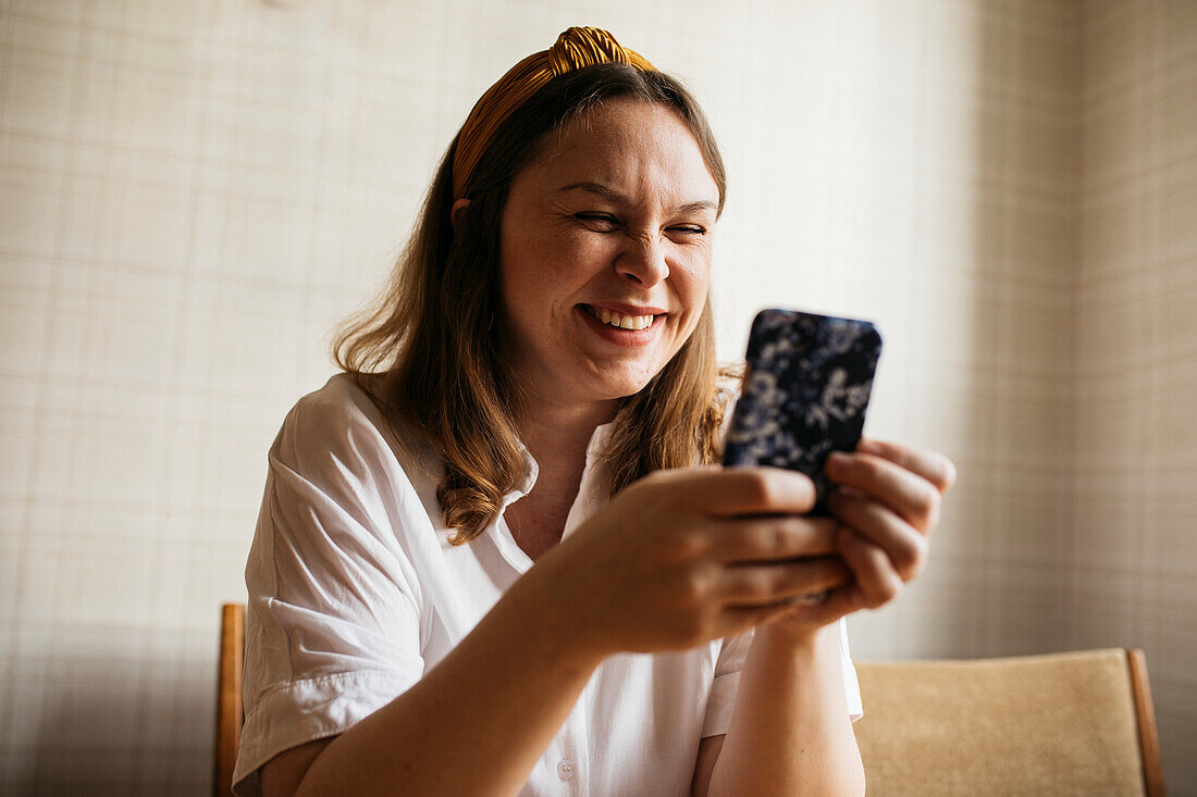 Smiling woman using cell phone