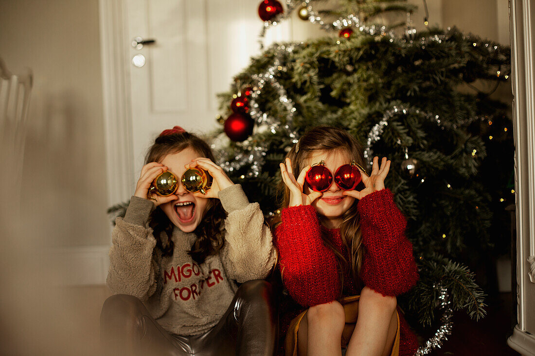 Girls in front of Christmas tree
