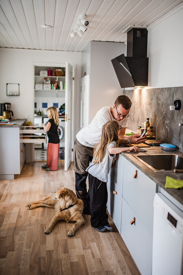 Father with daughter in kitchen