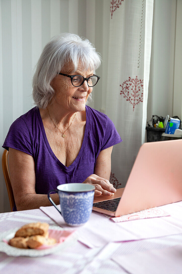 Senior woman using laptop