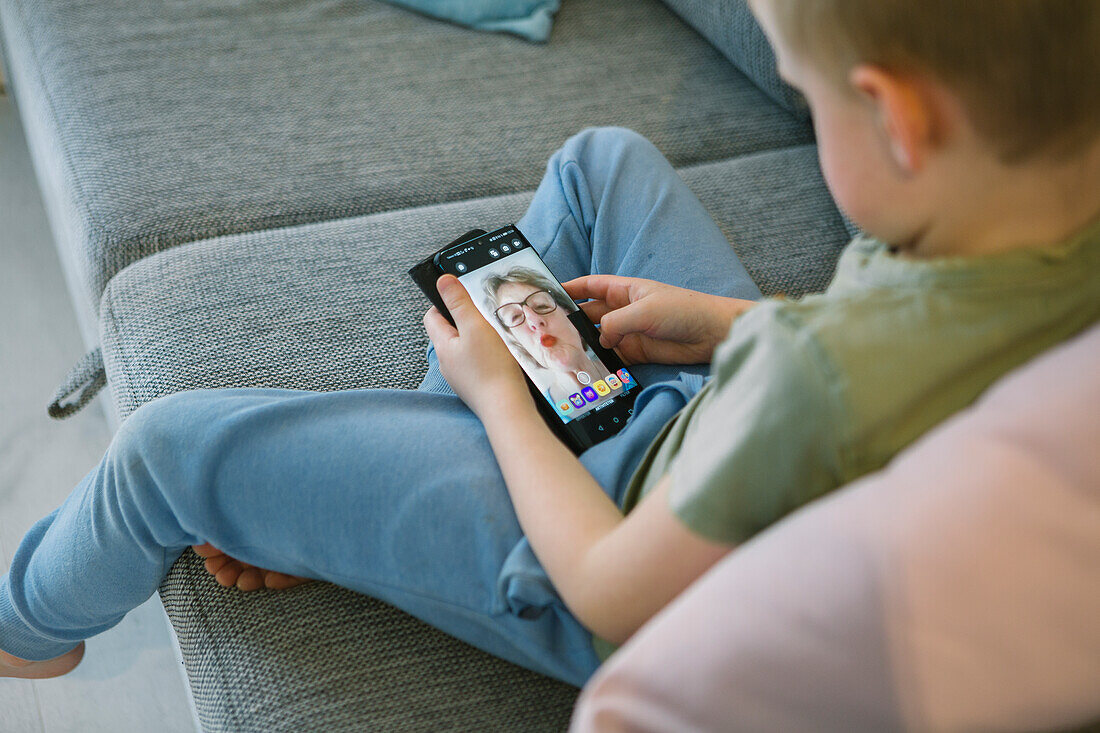 Boy talking with grandmother via video chat