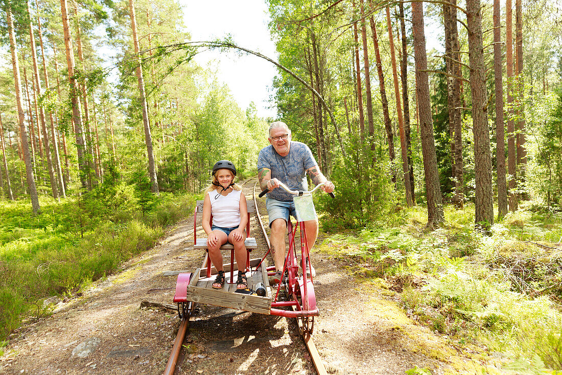 Father with daughter riding handcar