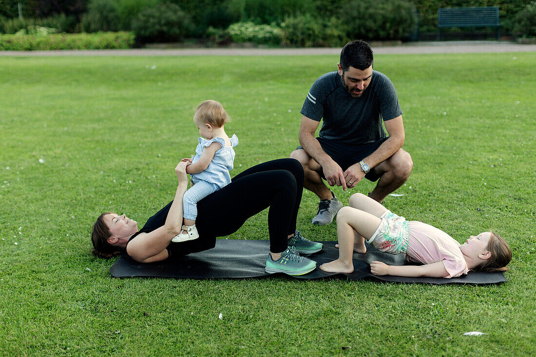 Family exercising in park