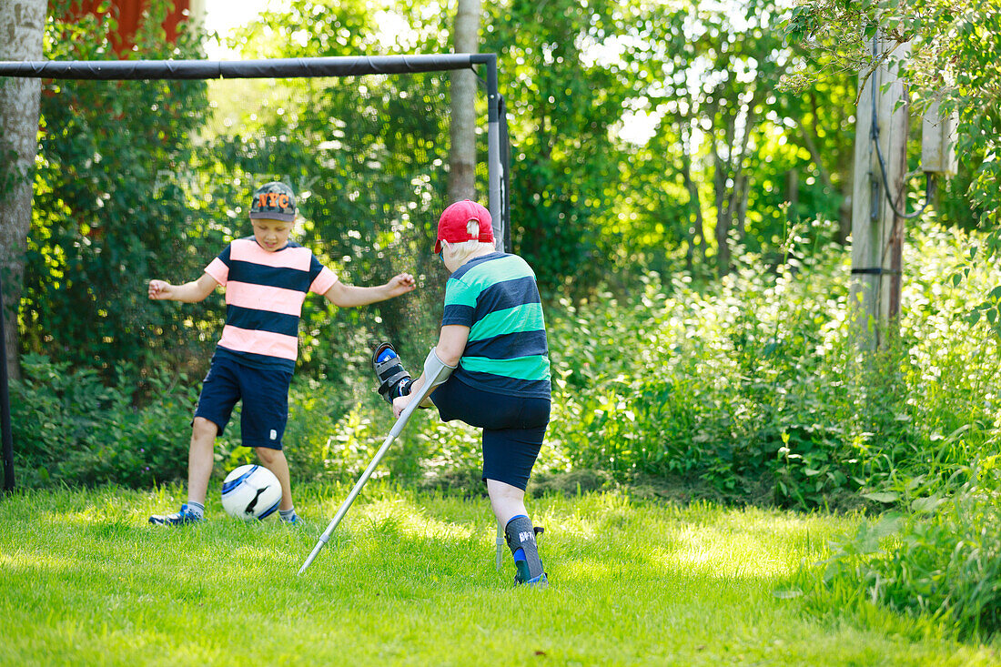 Boy playing football in garden