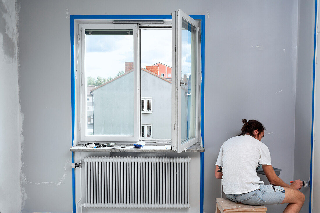 Man painting walls at home