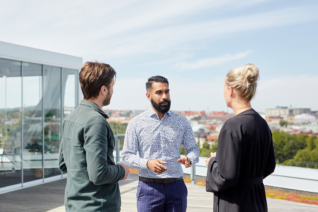 Coworkers talking during coffee break