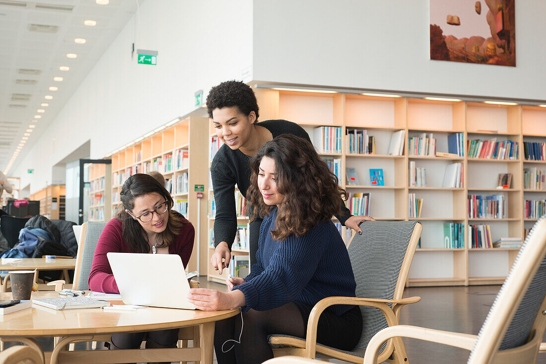 Women talking in library