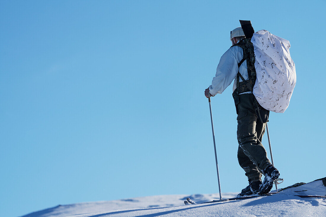 Cross country skier against blue sky