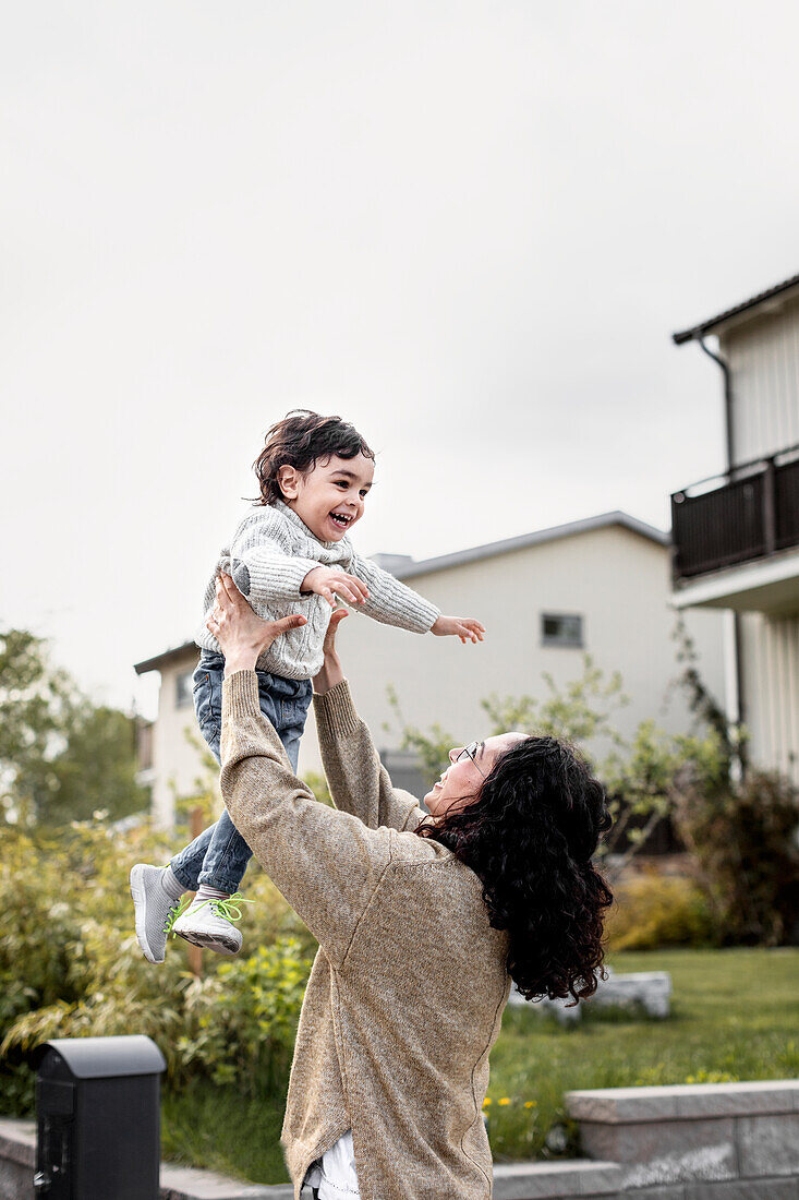 Woman playing with son