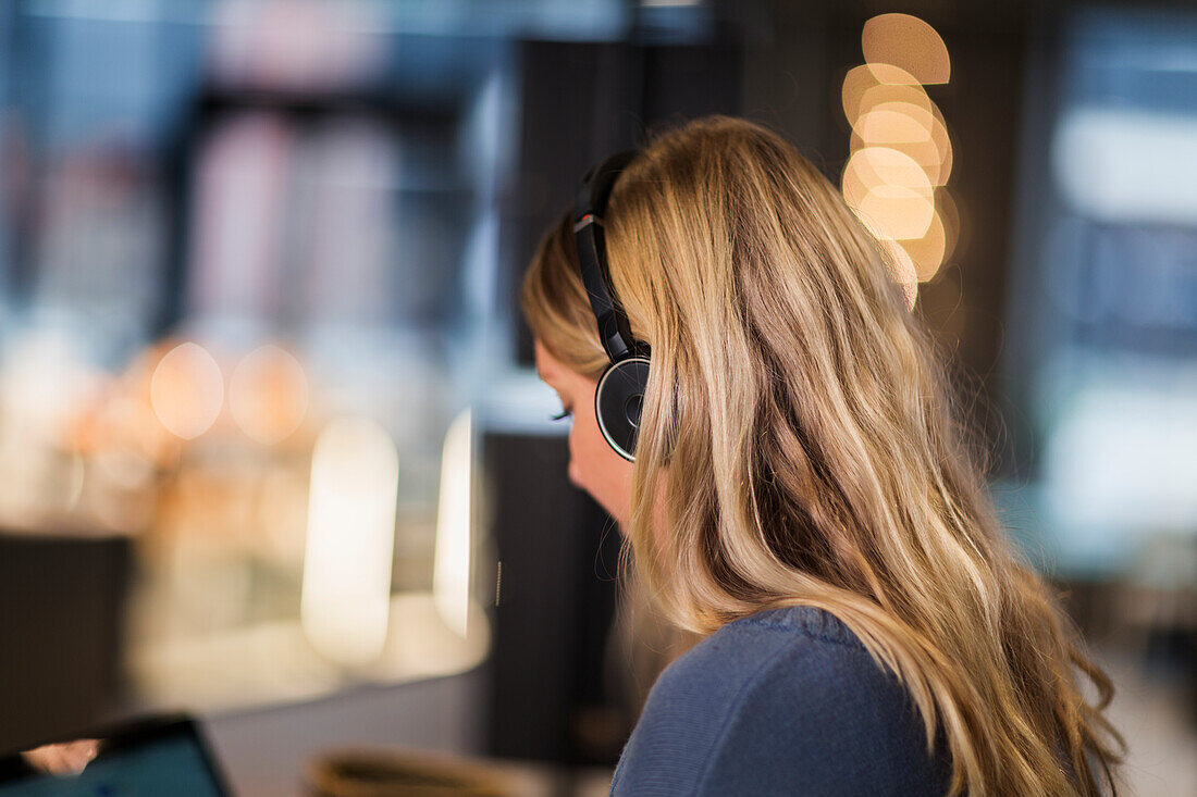 Woman wearing headset in office