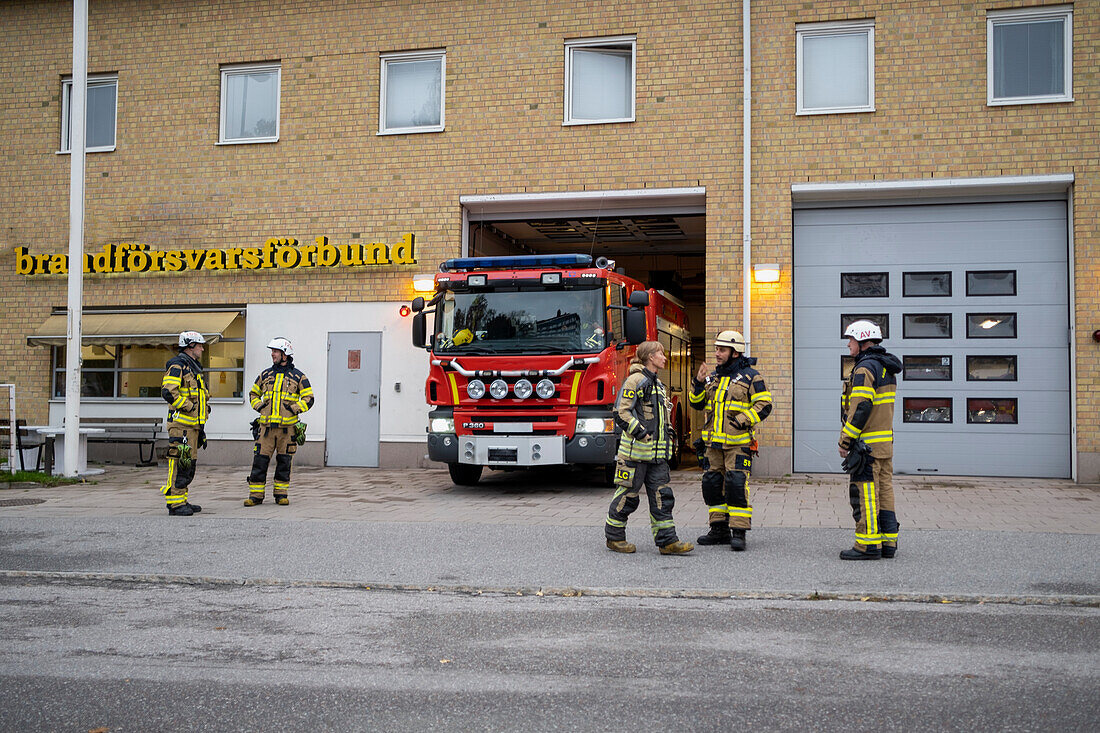 Firefighters in front of fire station