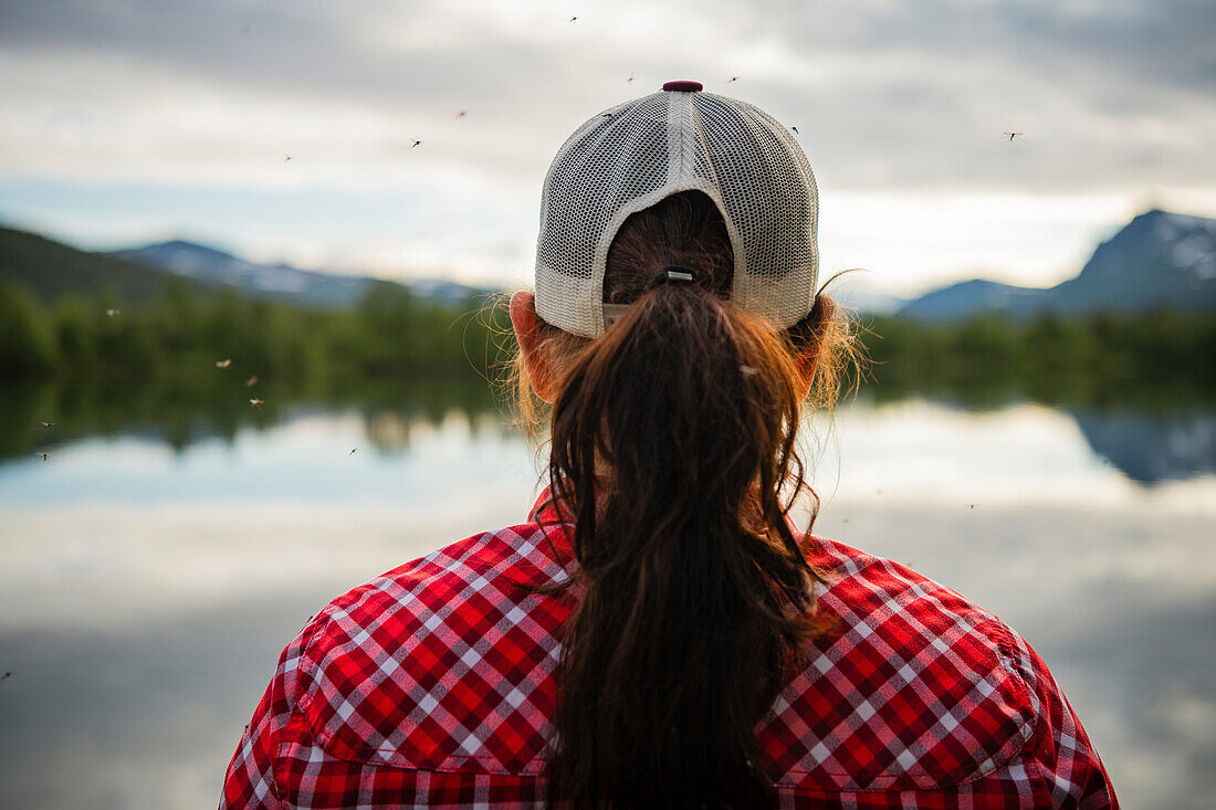 Rear view of woman at lake