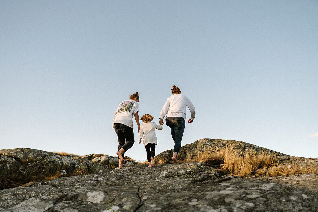 Rear view of women walking with girl