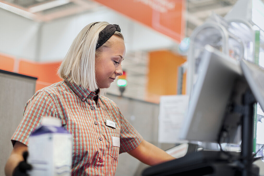 Smiling woman working at till