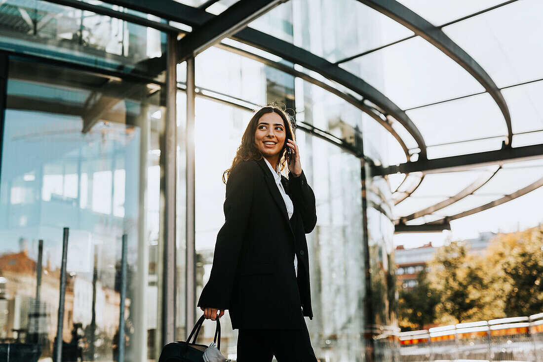 Smiling young woman on the phone