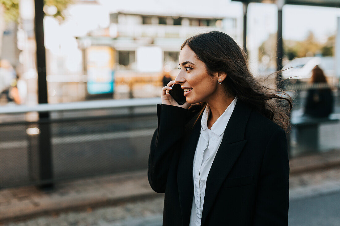 Smiling young woman on the phone