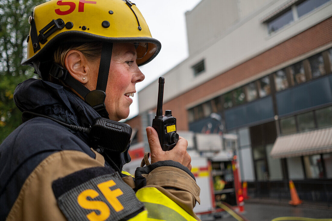 Firefighter talking via walkie talkie