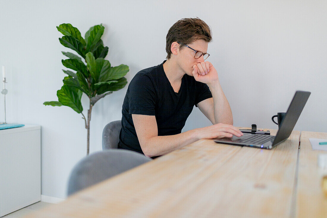 Man using laptop at home