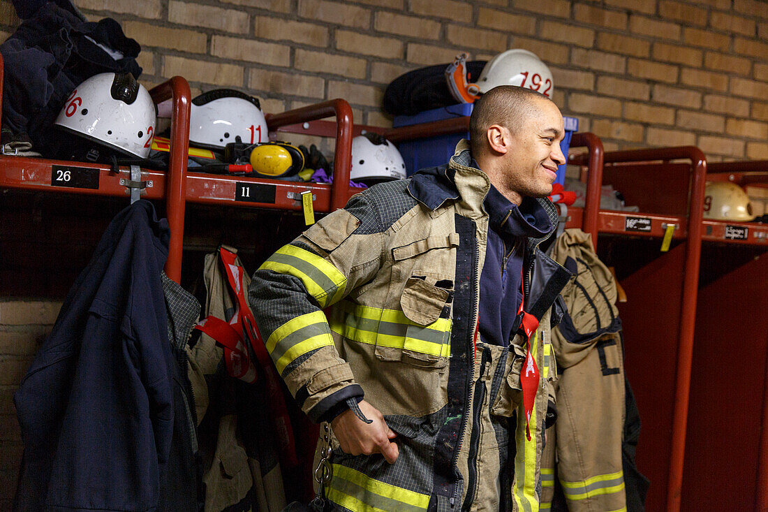 Smiling firefighter in locker