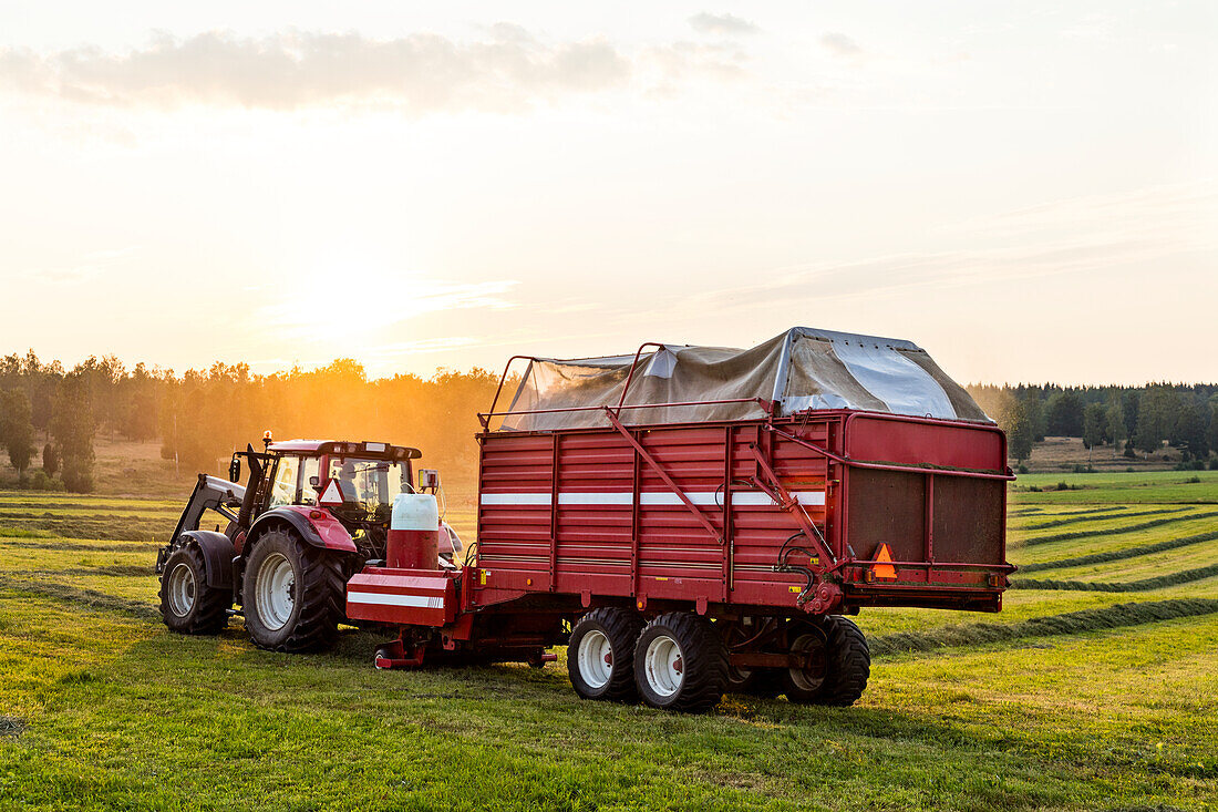 Tractor with loader wagon in field