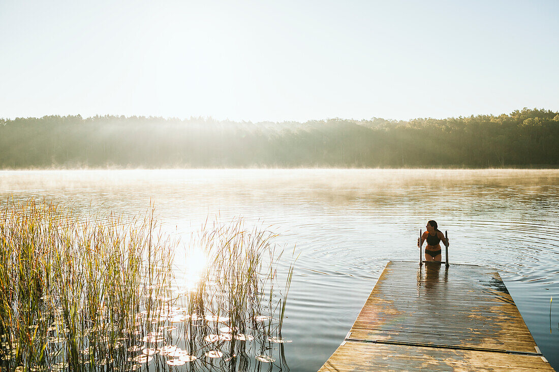 Woman getting out of lake