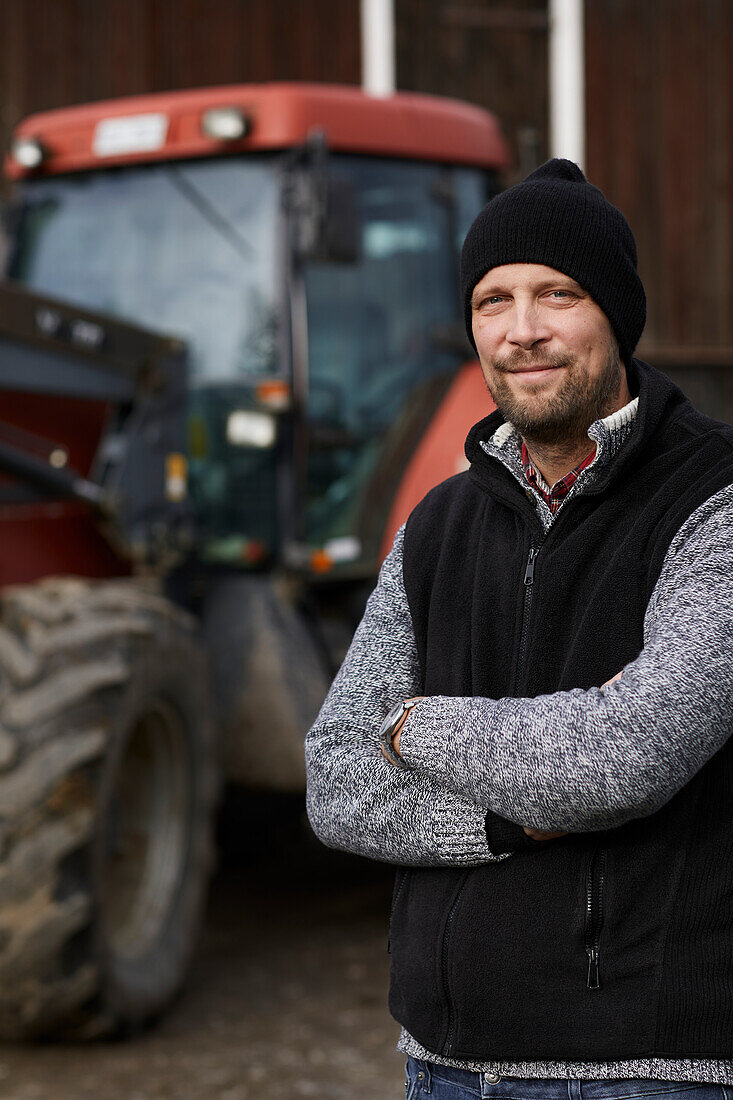 Farmer standing next to tractor