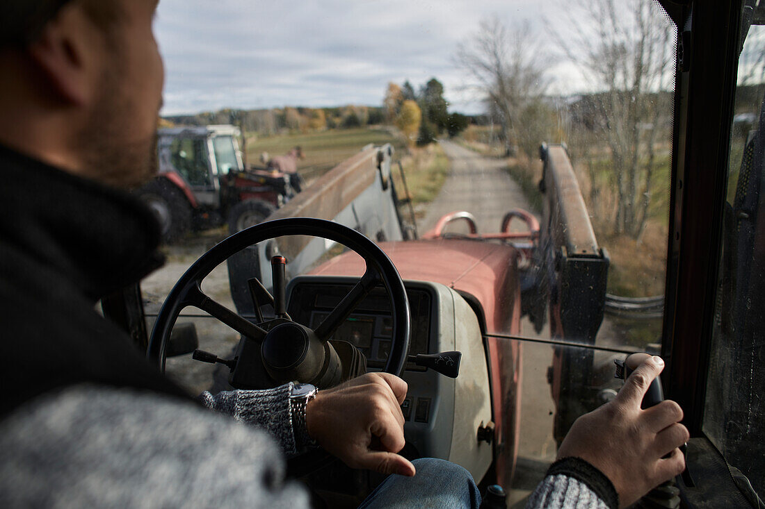 Farmer driving tractor