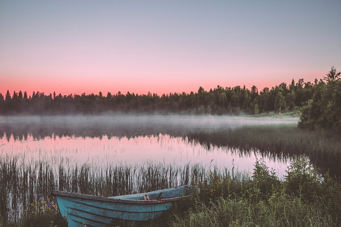 Abandoned boat at lakeshore