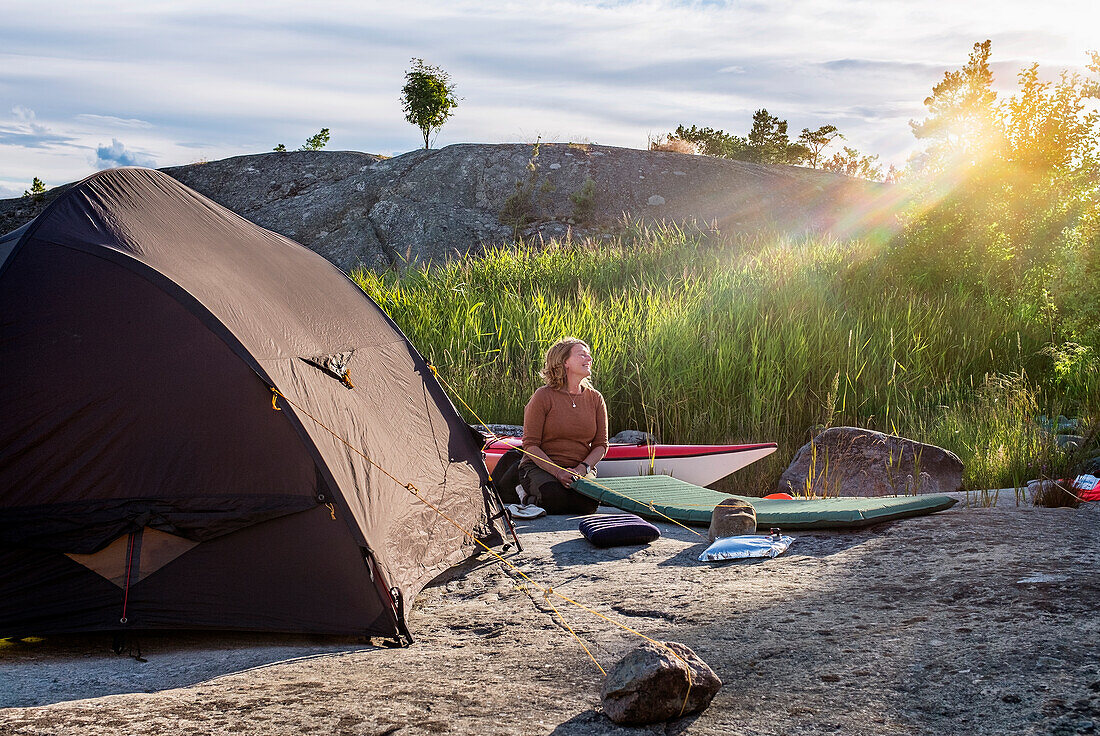 Woman sitting near tent