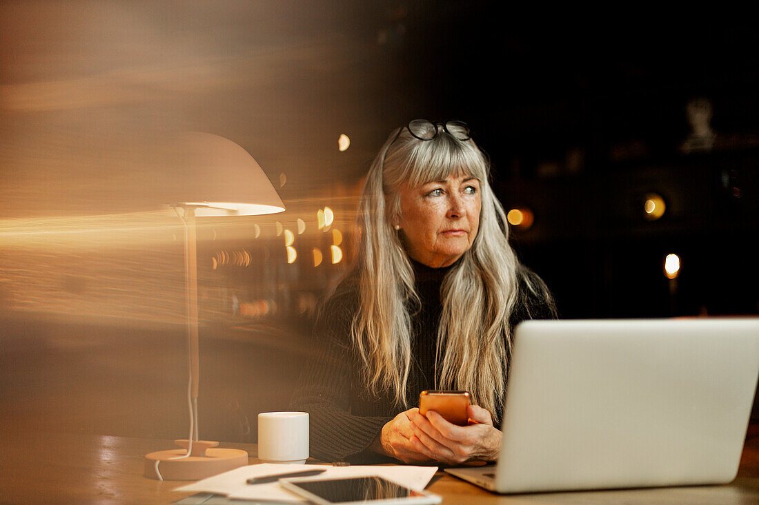 Mature businesswoman in cafe