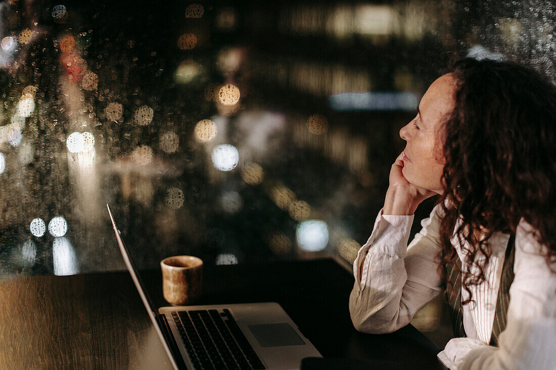 Woman in office at night