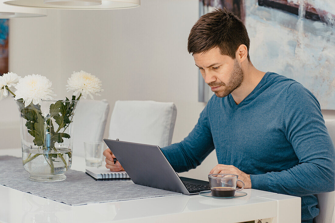 Man using laptop at home