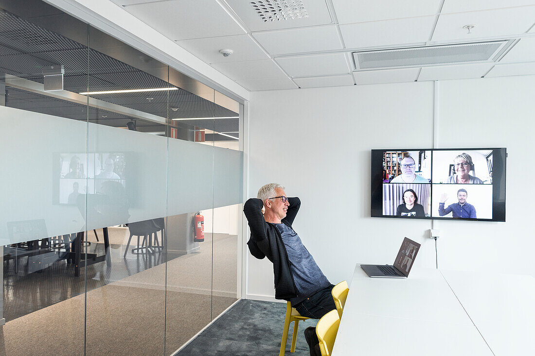 Man in boardroom having video conference