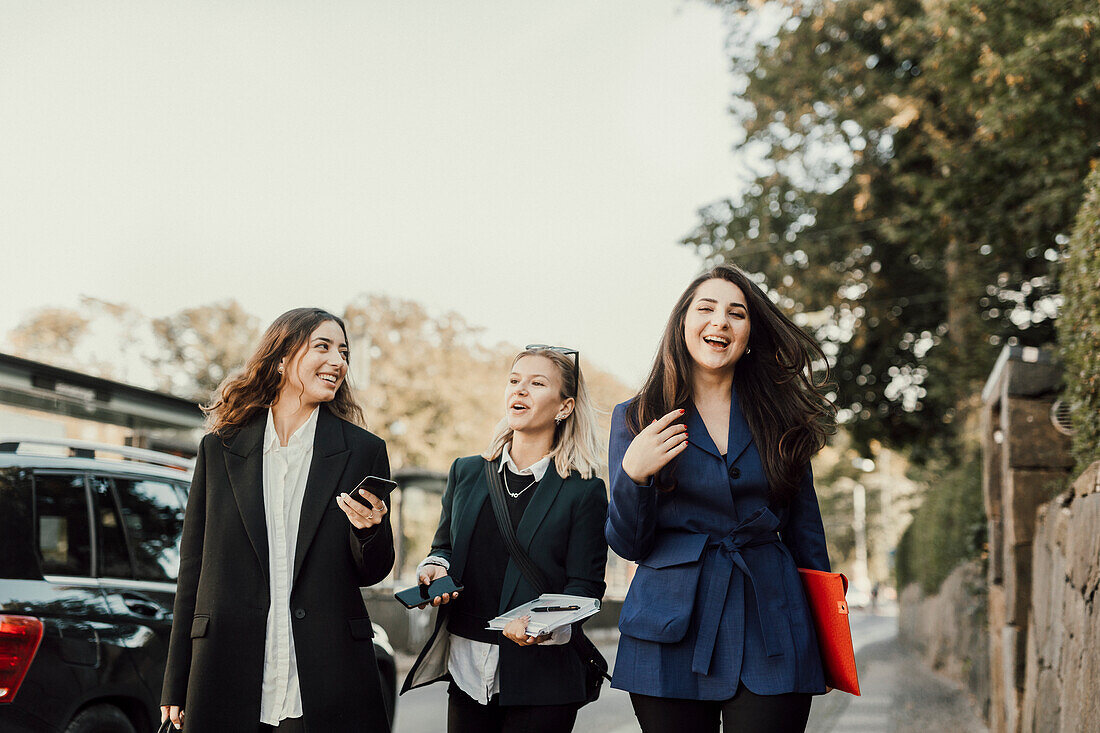 Female coworkers walking together