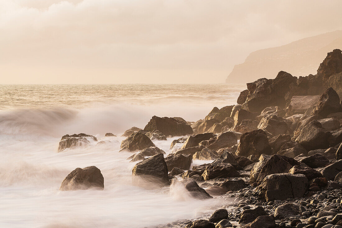 View of rocky coast at sunset