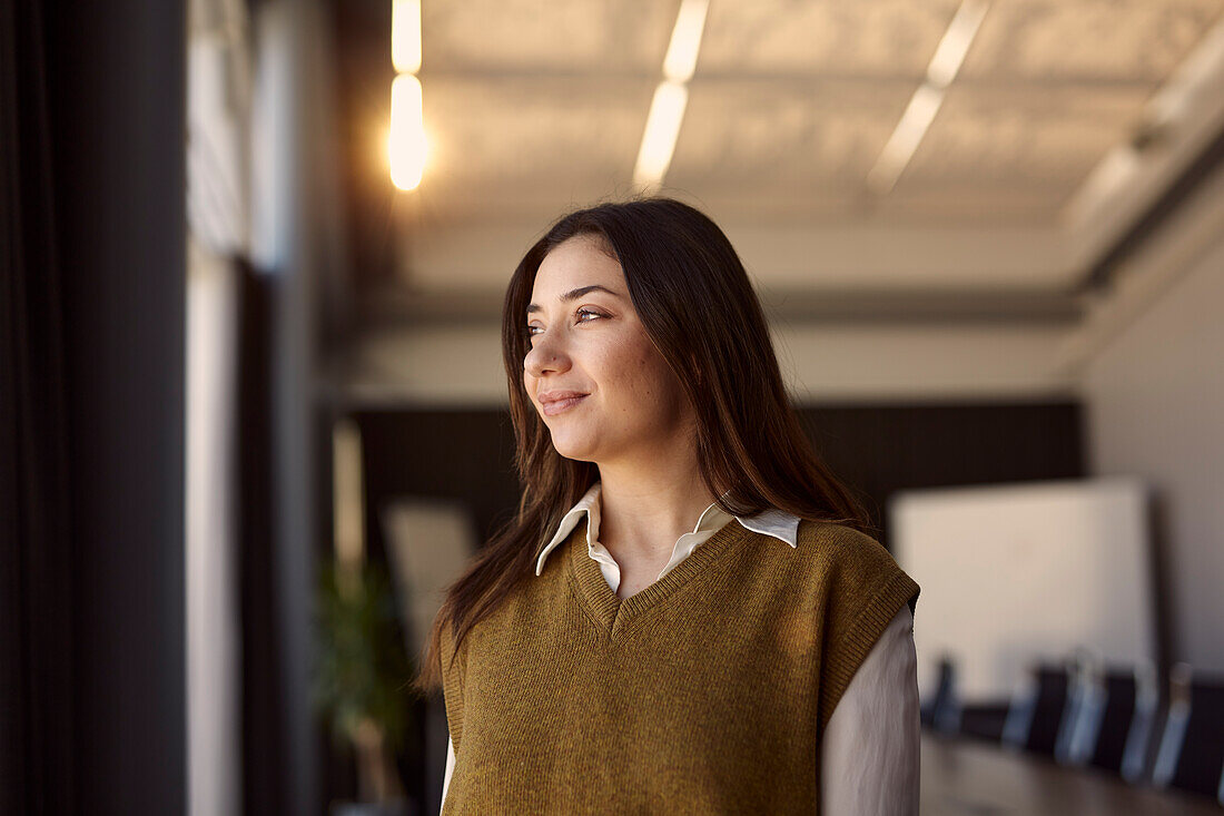 Smiling young woman looking away