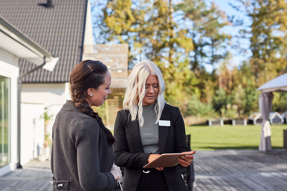 Estate agent talking to client