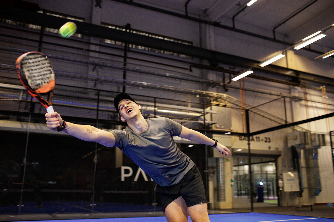 Man playing padel at indoor court
