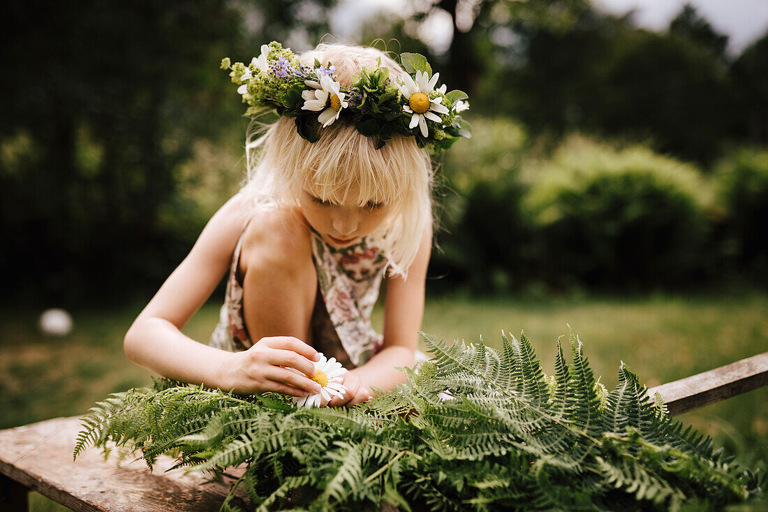 Girl in garden preparing maypole in garden