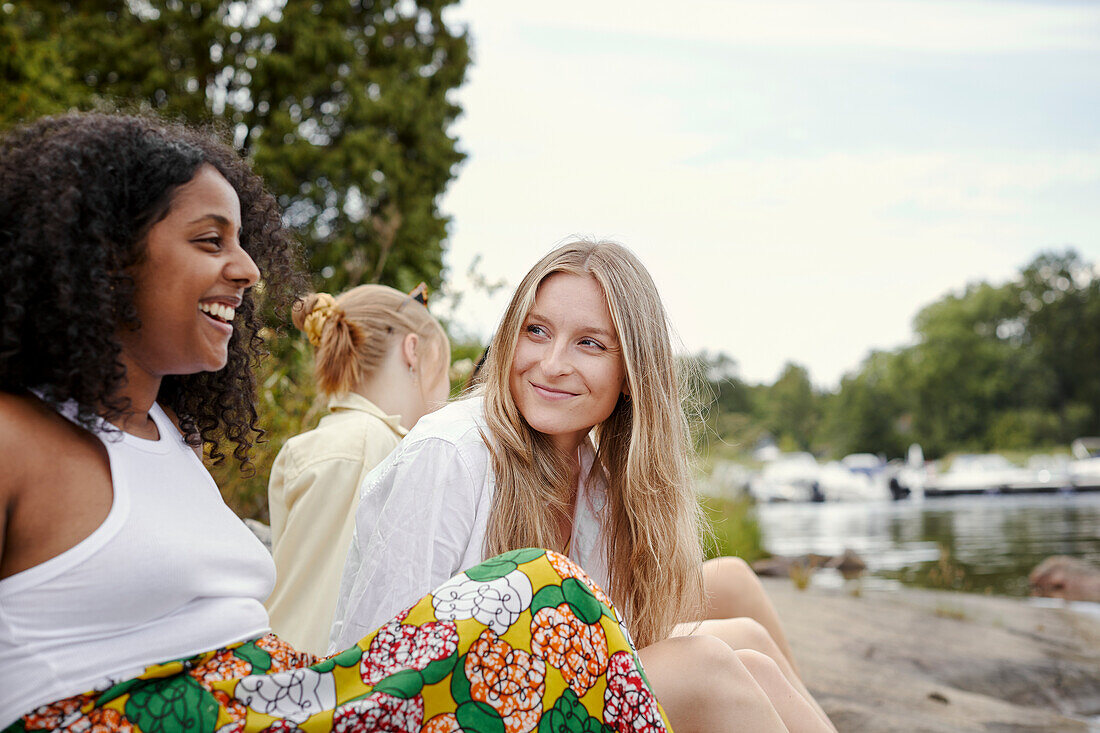 Group of friends resting at lakeside