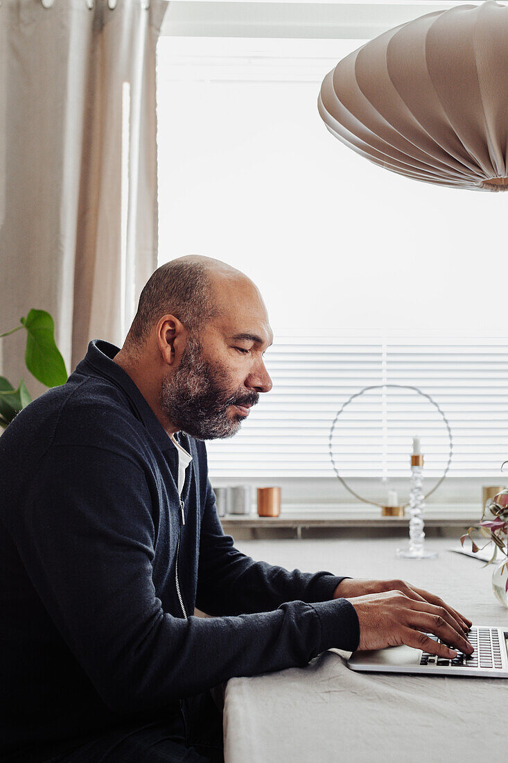 Man using laptop at home