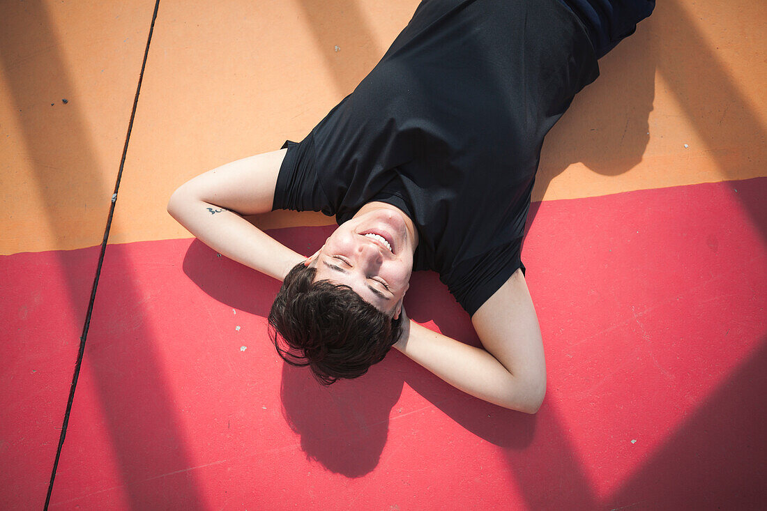 Young woman lying on colorful ground