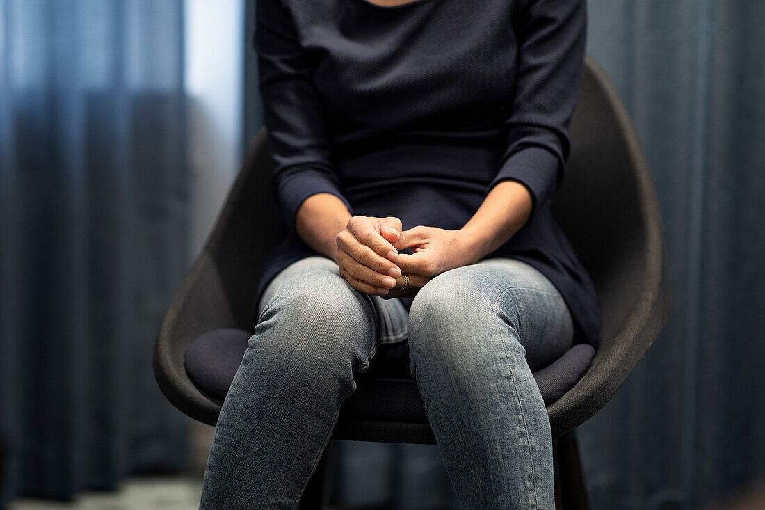 Mid section of woman sitting during meeting