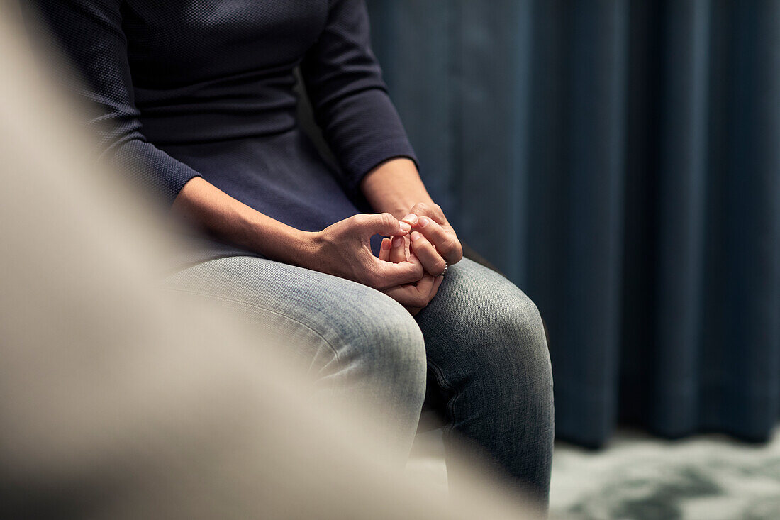 Mid section of woman sitting during meeting