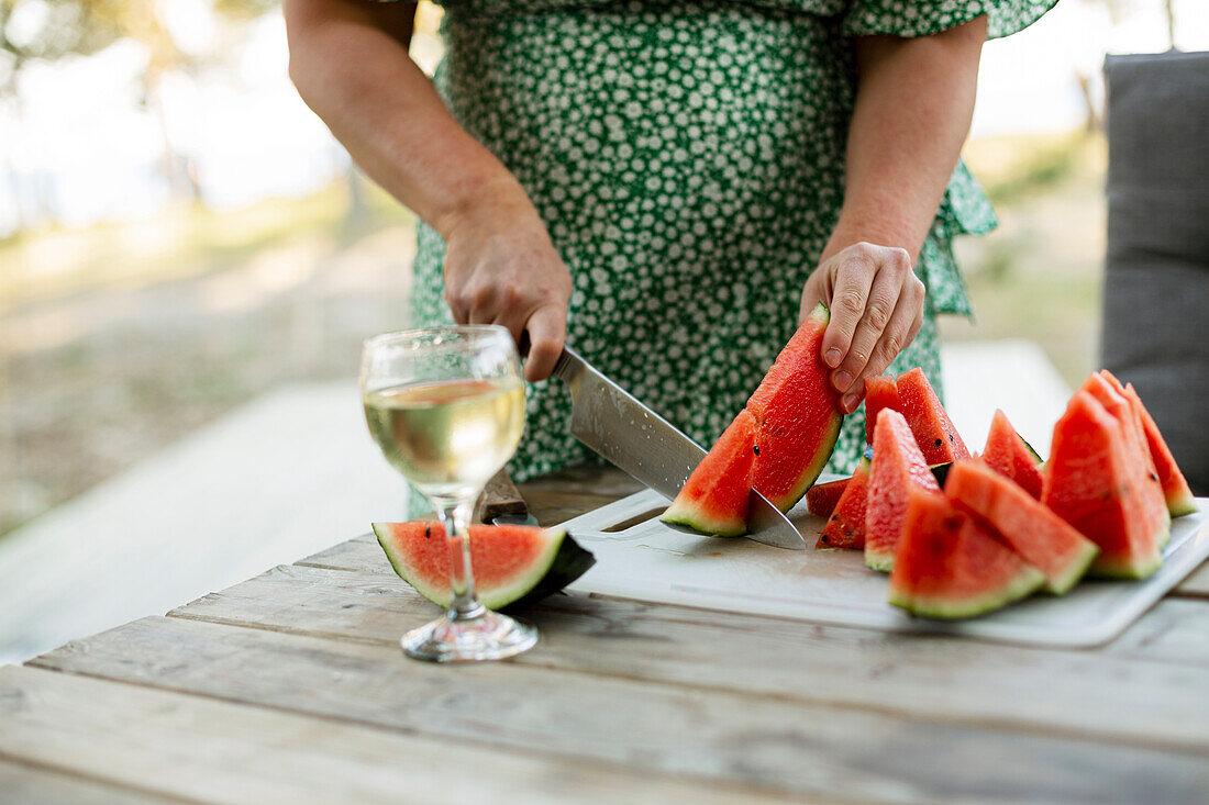 Woman cutting watermelon