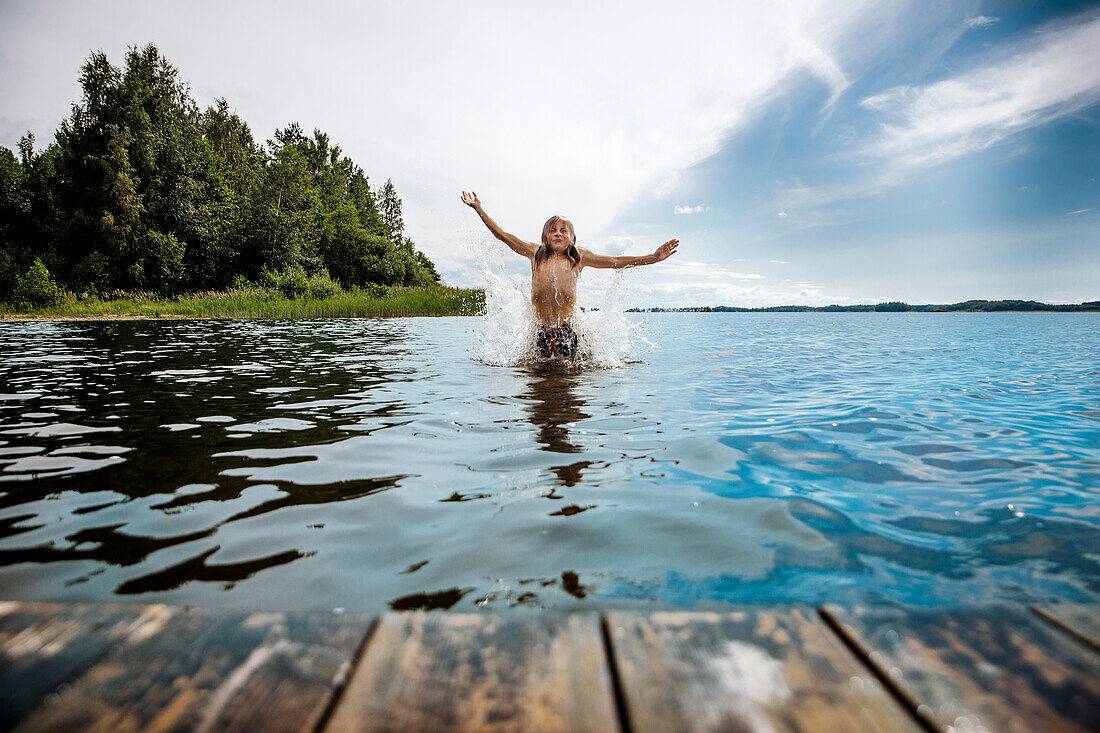 Boy splashing in sea